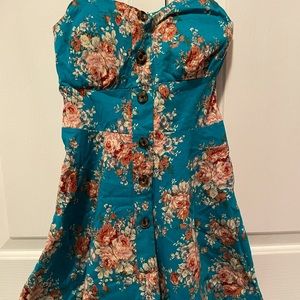 NWOT Super cute, teal strappy dress with floral print and brown buttons.